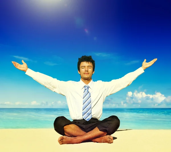 Businessman meditating on the beach — Stock Photo, Image