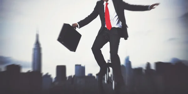 Businessman riding one wheel bicycle — Stock Photo, Image