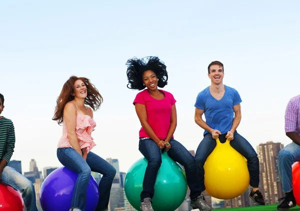 Diversity people with hoppity horses — Stock Photo, Image