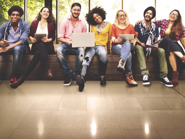 Amigos sentados en el banco con computadoras portátiles — Foto de Stock