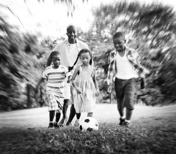 Vater und seine Söhne und Tochter spielen Fußball — Stockfoto