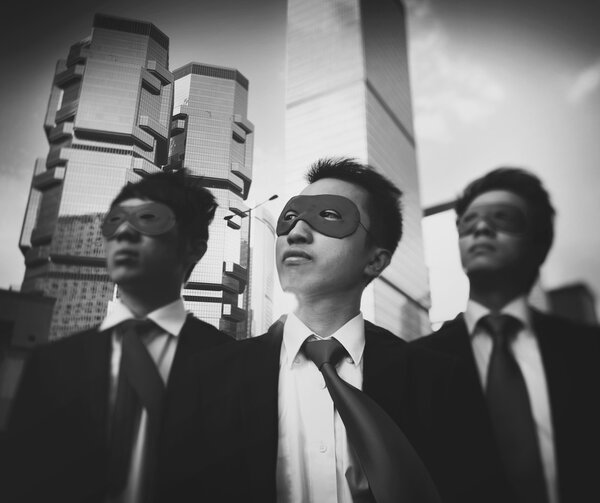 businessmen in superhero masks  