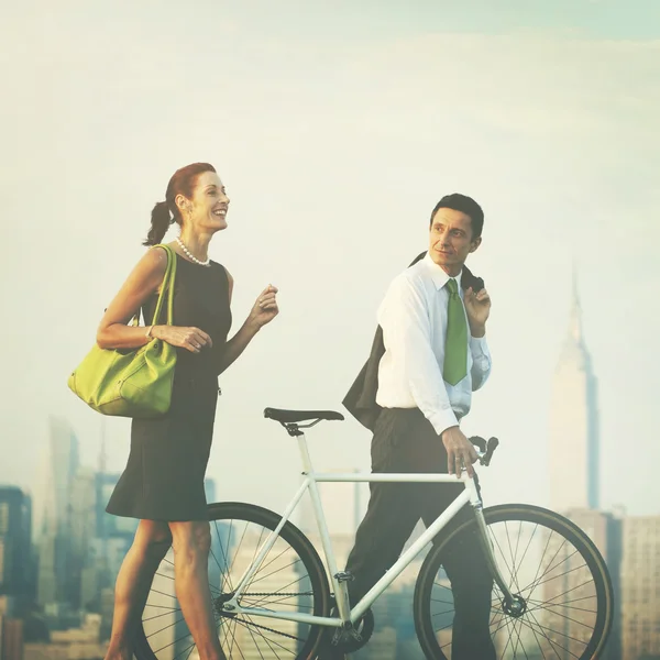 Business couple with bicycle — Stock Photo, Image