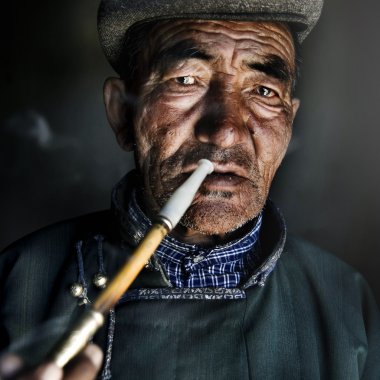 Moğol adam pipoyla Sigara