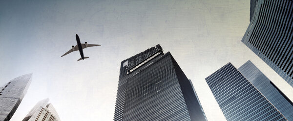 Airplane flying over city buildings, Skyscraper Concept