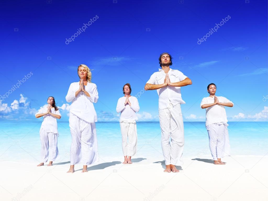 People performing yoga on the beach Concept
