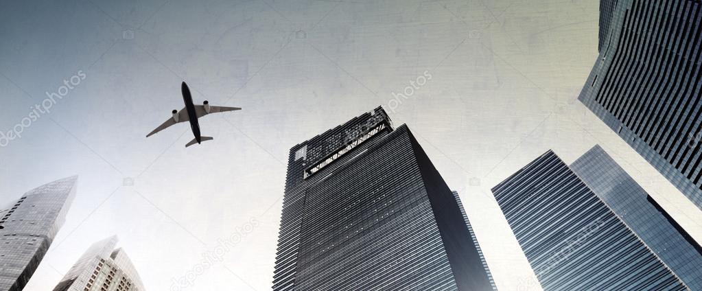 airplane flying over city buildings