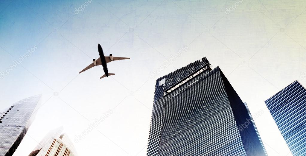 airplane flying over city buildings