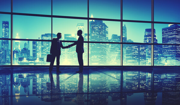 Businessmen shaking hands, work and skyscrapers concept