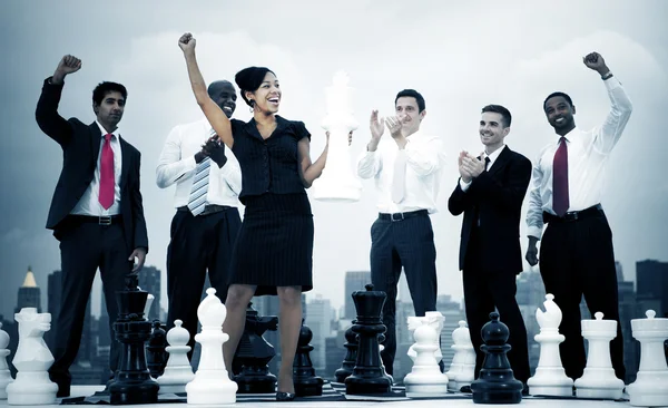 Business people celebrating with chess — Stock fotografie