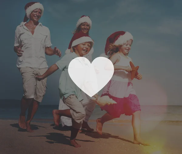 Family at beach in santa hats — Stock Photo, Image