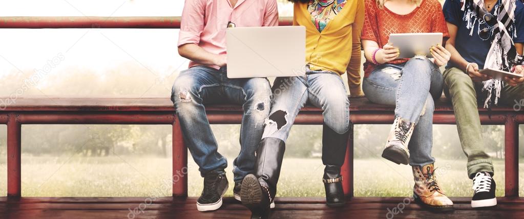 friends on bench with laptop and tablet pc