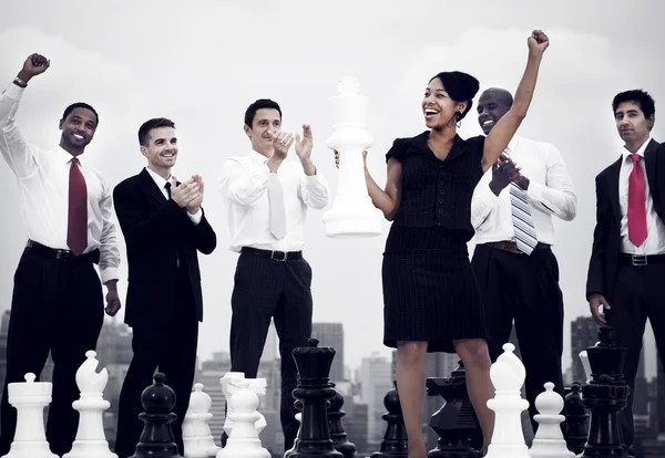 Business people celebrating with chess — Stockfoto