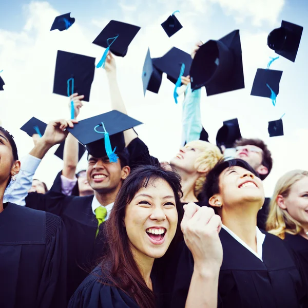 Estudantes jogar bonés no ar — Fotografia de Stock