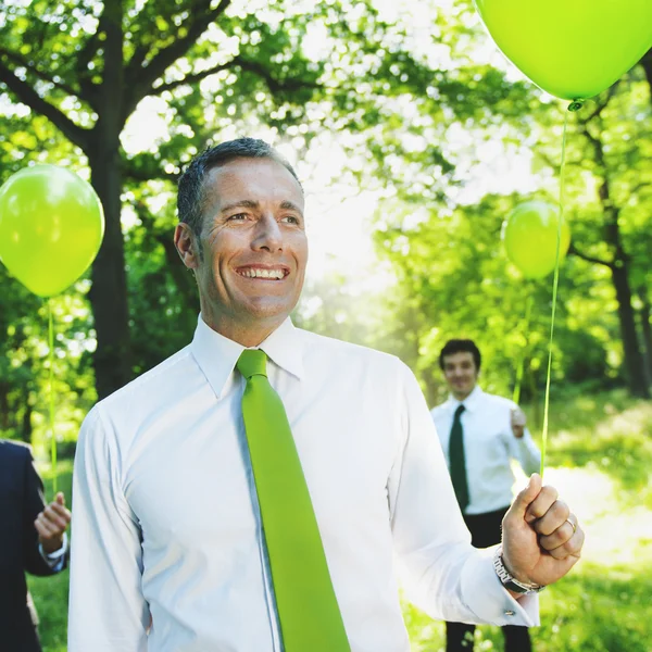 Business people with balloons — Stock Photo, Image