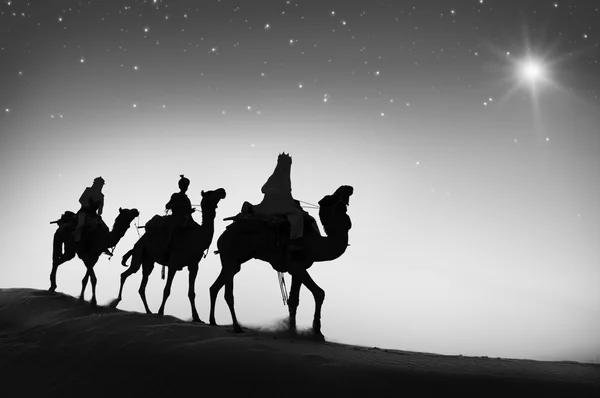 Men riding camels through desert — Stock Photo, Image