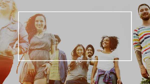 Cheerful students walking in college park — Stock Photo, Image