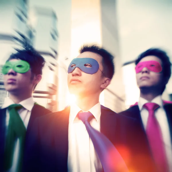 Бизнесмены в супергеройских масках — стоковое фото