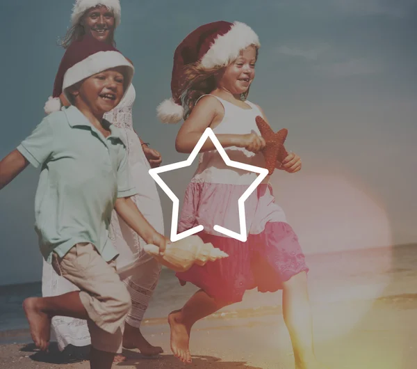 Family at beach in santa hats — Stock Photo, Image