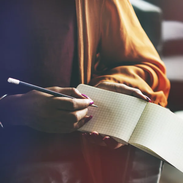 Woman writing in notebook — Stock Photo, Image