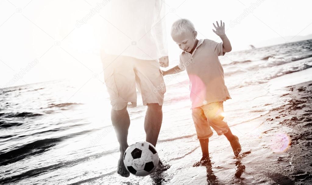 Father and Son Playing Soccer Concept