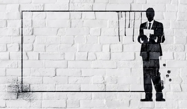 Grafidade preta na parede de tijolo branco — Fotografia de Stock