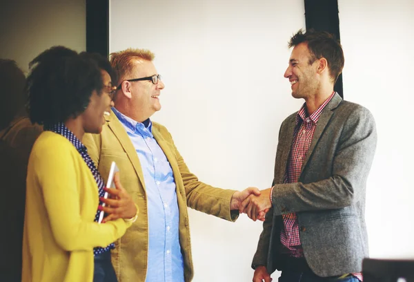 Business people handshaking to confirm deal