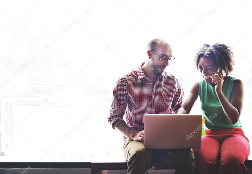 couple on bench with laptop computer