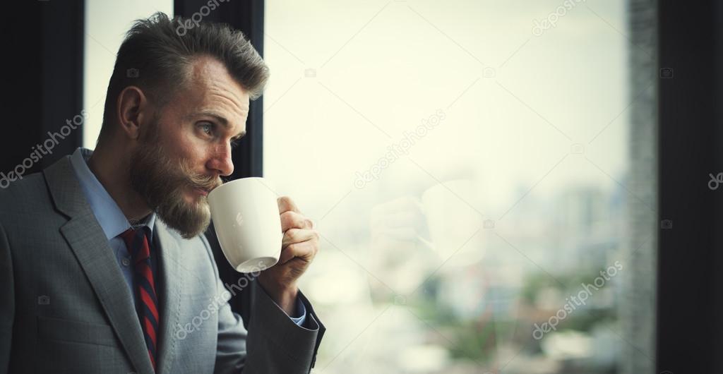 Businessman holding cup of coffee