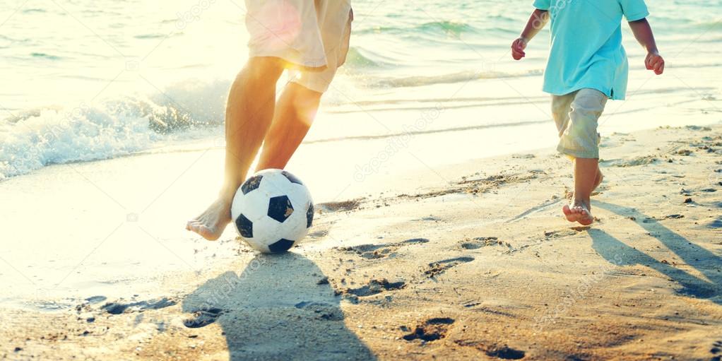 Father Son Playing Soccer at Beach