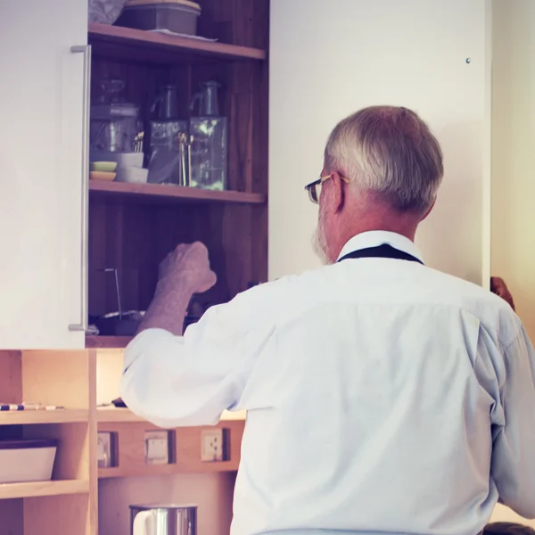 Mature man taking cooking ingredients — Stock Photo, Image