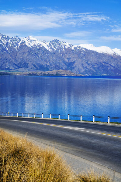 Road With Lake And Mountain Range