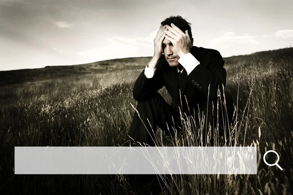 Businessman holding hands on head — Stock Photo, Image