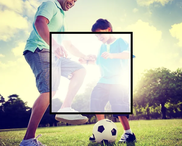 Father playing football with little son — Stockfoto