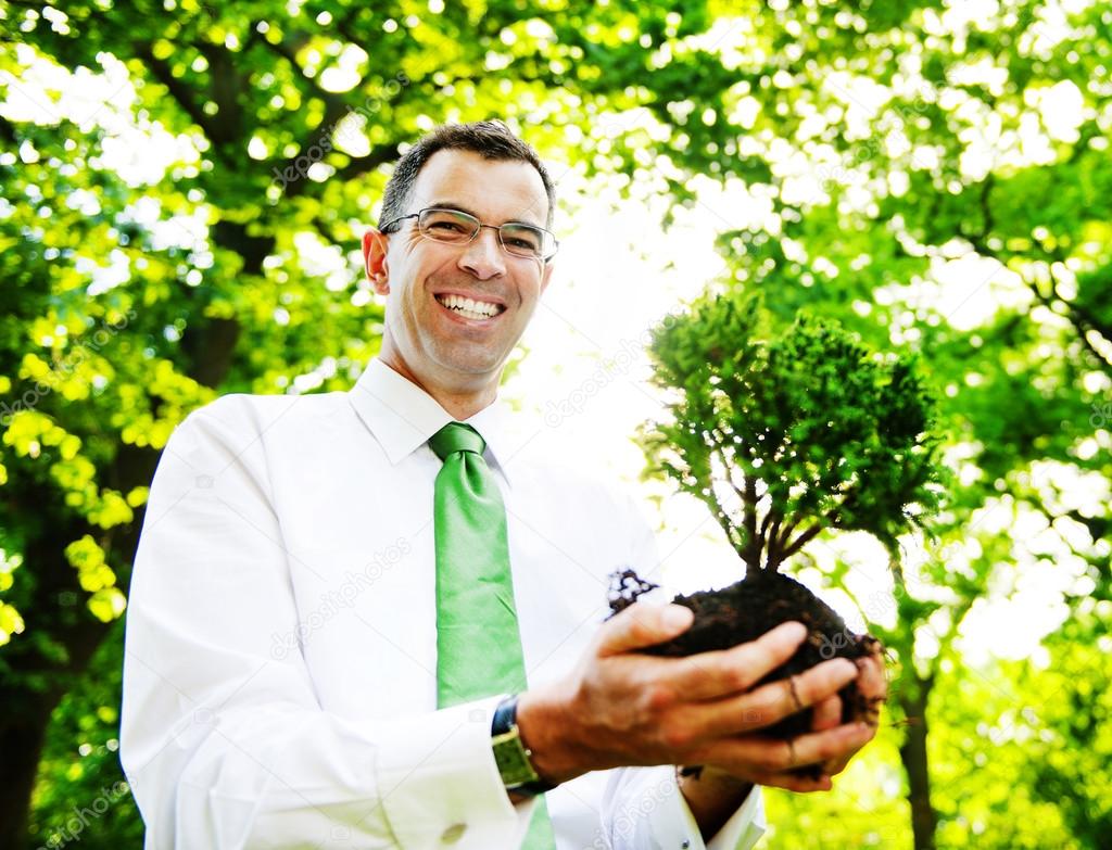 Businessman Holding Tree Plant
