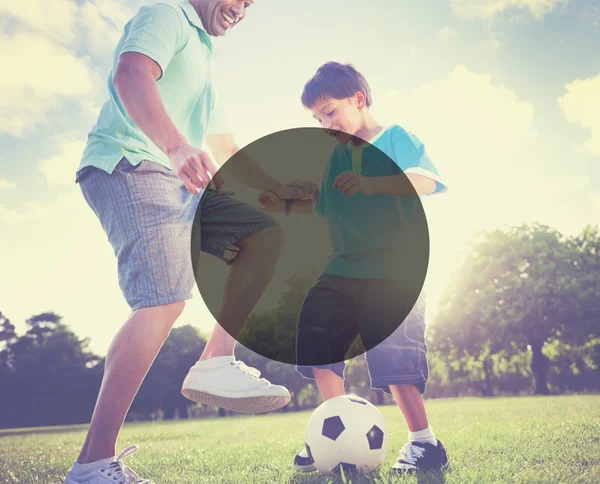 Father playing football with little son — Stockfoto