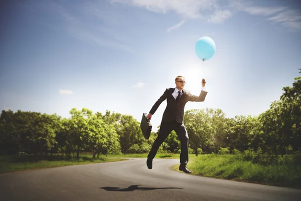 Empresário alegre com balão — Fotografia de Stock