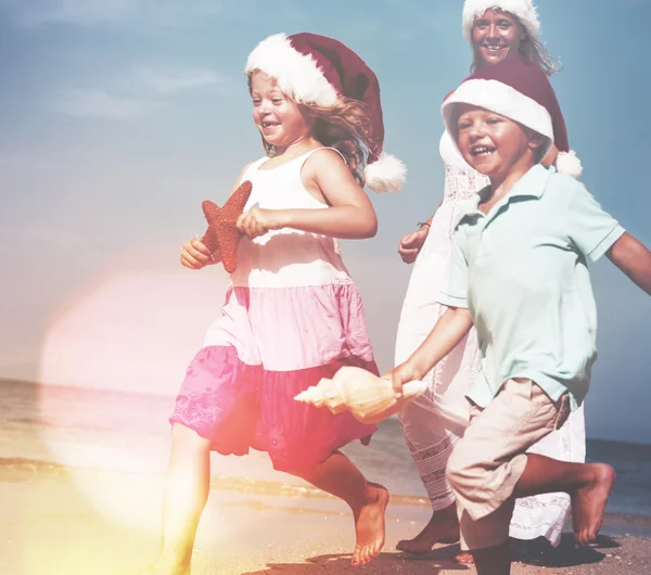 Family With Christmas Hats on Beach — Stock Photo, Image