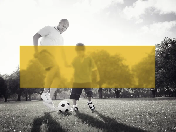 Father playing football with little son — Stockfoto