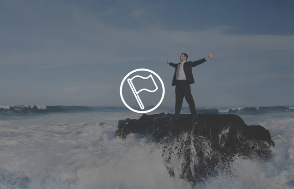 Businessman standing on sea rock — Stock Photo, Image