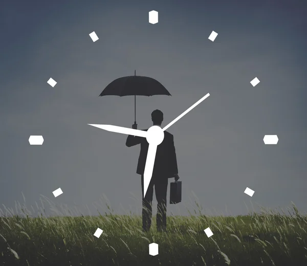 Podnikatel s deštníkem stojící — Stock fotografie