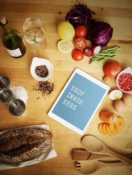 Цифровой планшет на кухне с продуктами питания — стоковое фото