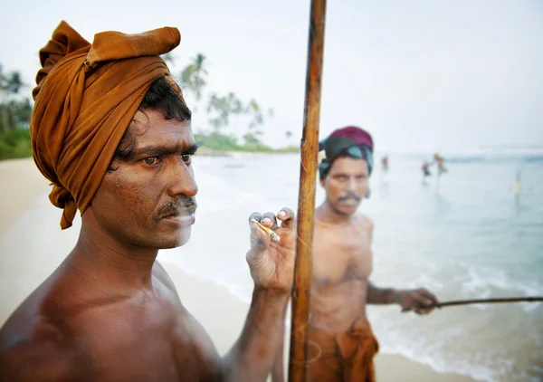 Fisherman smoking by shore — Stock Photo, Image