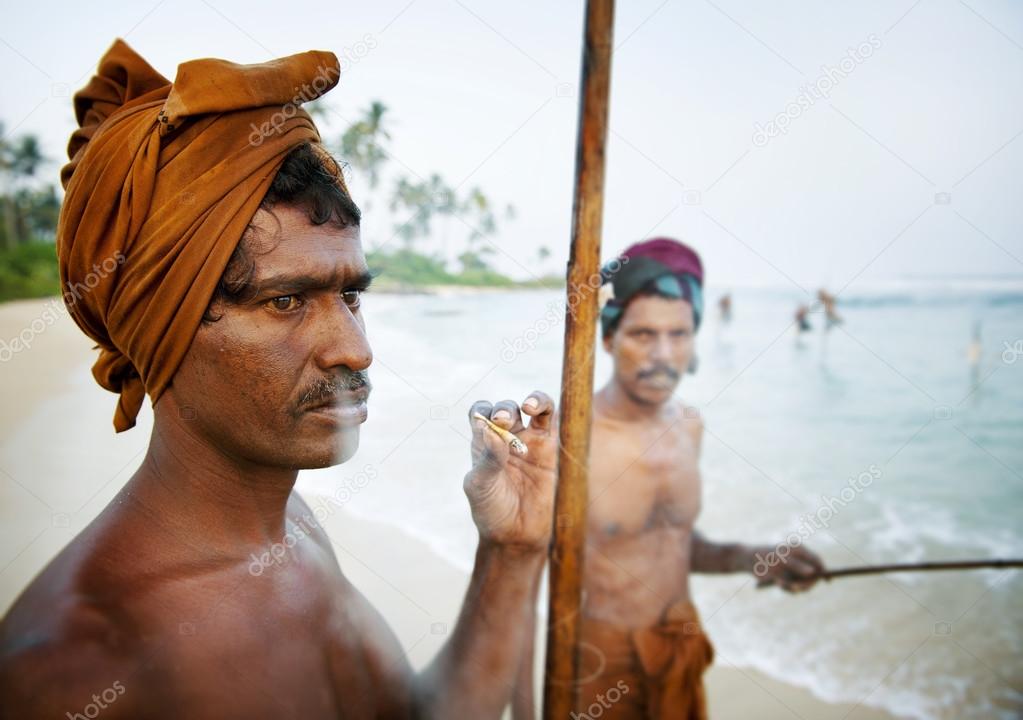 Fisherman smoking by shore