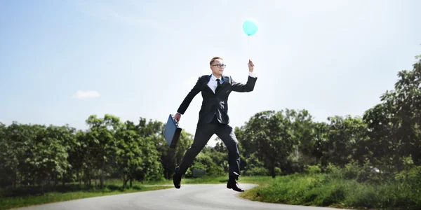 Joyful businessman with balloon — Stock Photo, Image