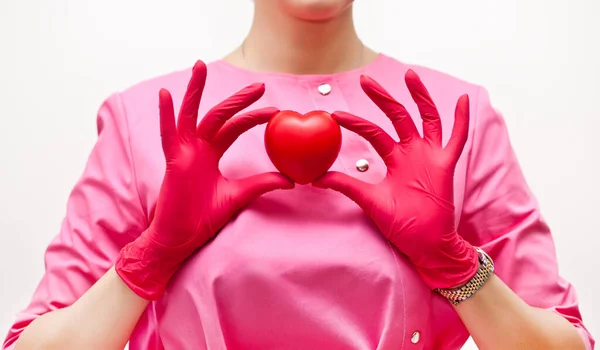 Wanita dalam seragam medis memegang hati di tangan. — Stok Foto