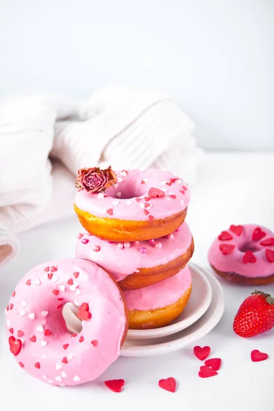 Stack of pink doughnuts on the plate. Valentines Day concept.