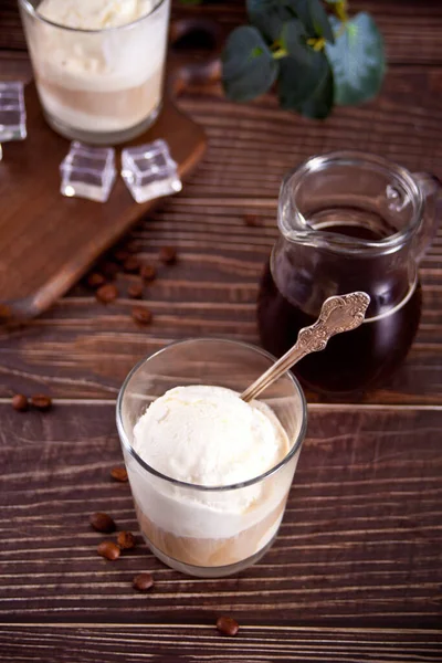 Affogato coffee with ice cream in a glass on the wooden table