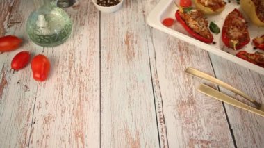 Woman hand put on table plate of fresh spring salad with arugula, feta cheese and tomatoes