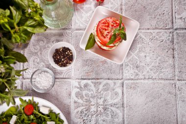 Caprese salad with mozarella cheese, tomatoes and basil. Top view. Copy space.